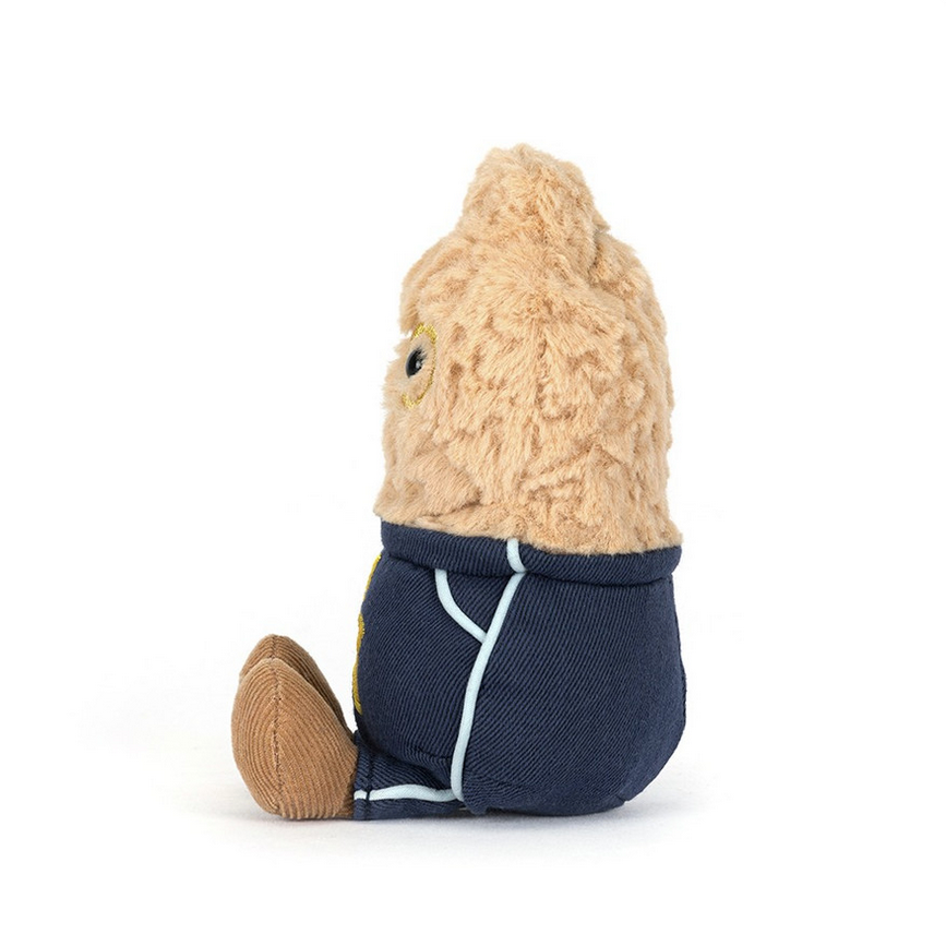 Stuffed toy resembling a peanut with a navy blue outfit on a white background