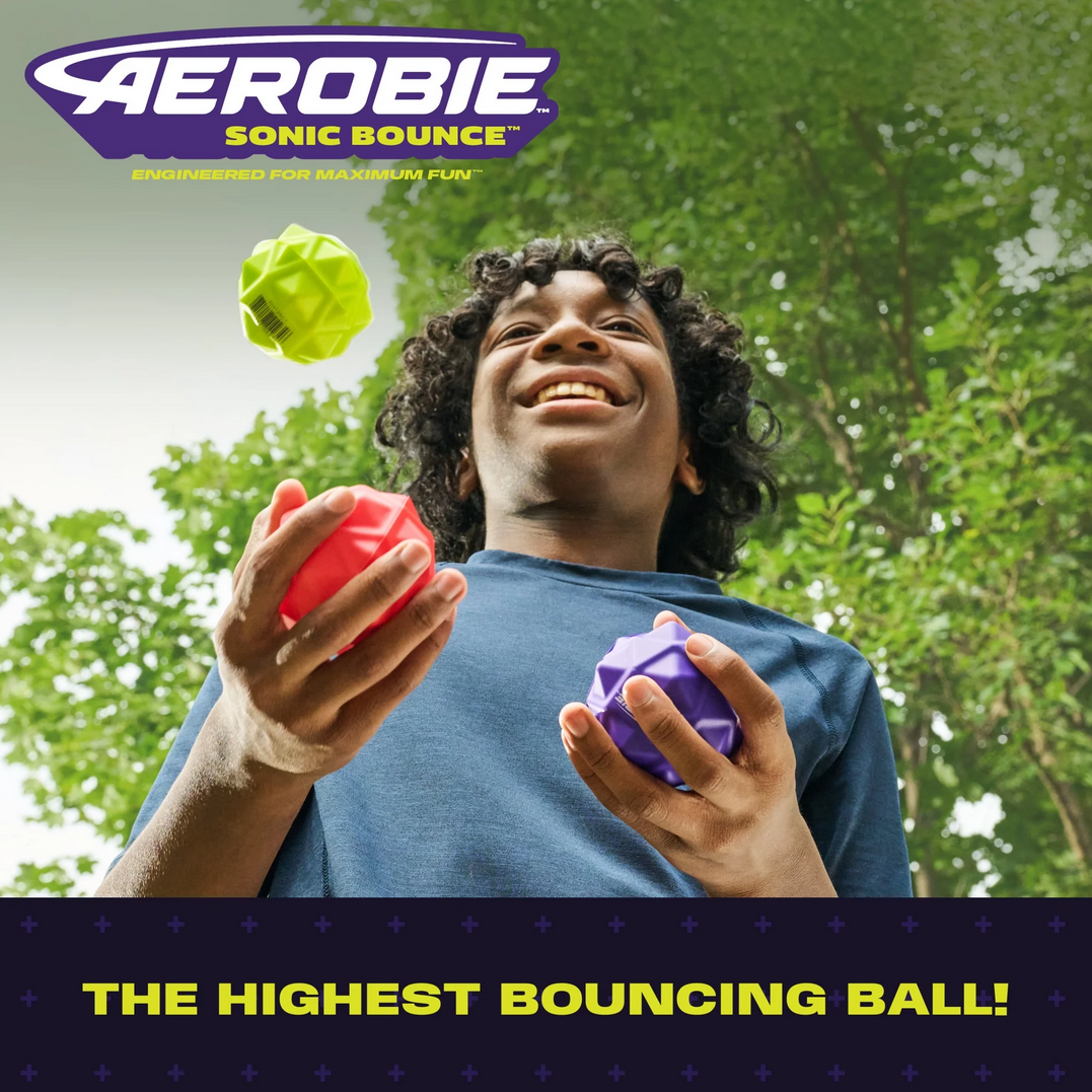 Person holding colorful bouncing balls with Aerobie logo and text about highest bouncing ball.