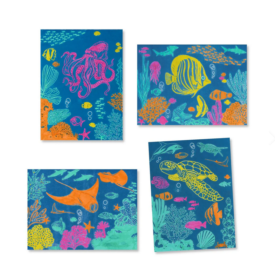 Set of four colorful ocean-themed notebooks with various sea creatures on a blue background.