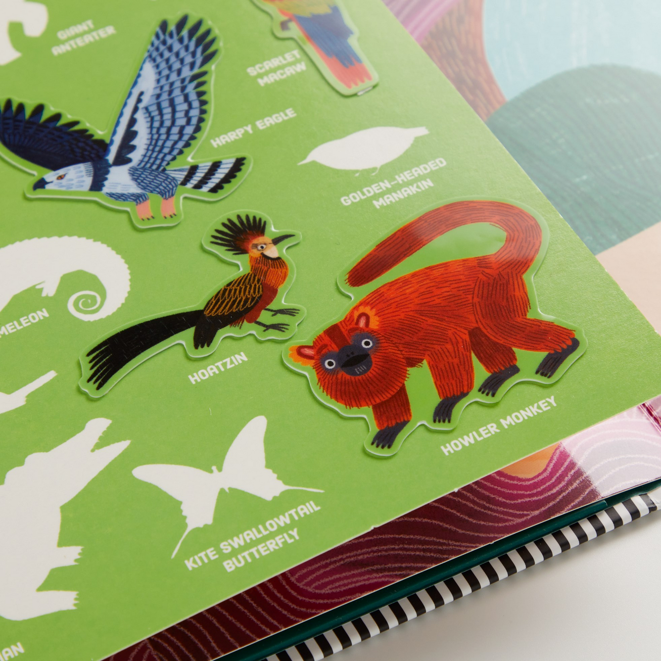 Children's book with animal stickers on a green page