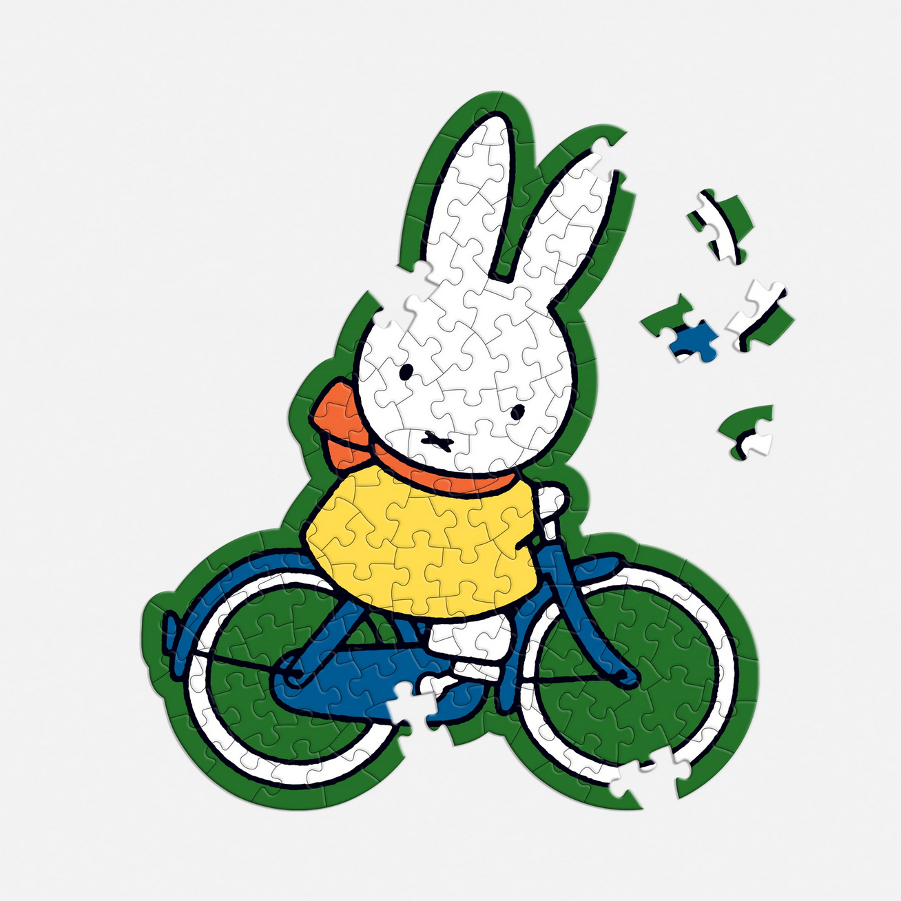 Jigsaw puzzle of a cartoon rabbit on a bicycle with missing pieces.
