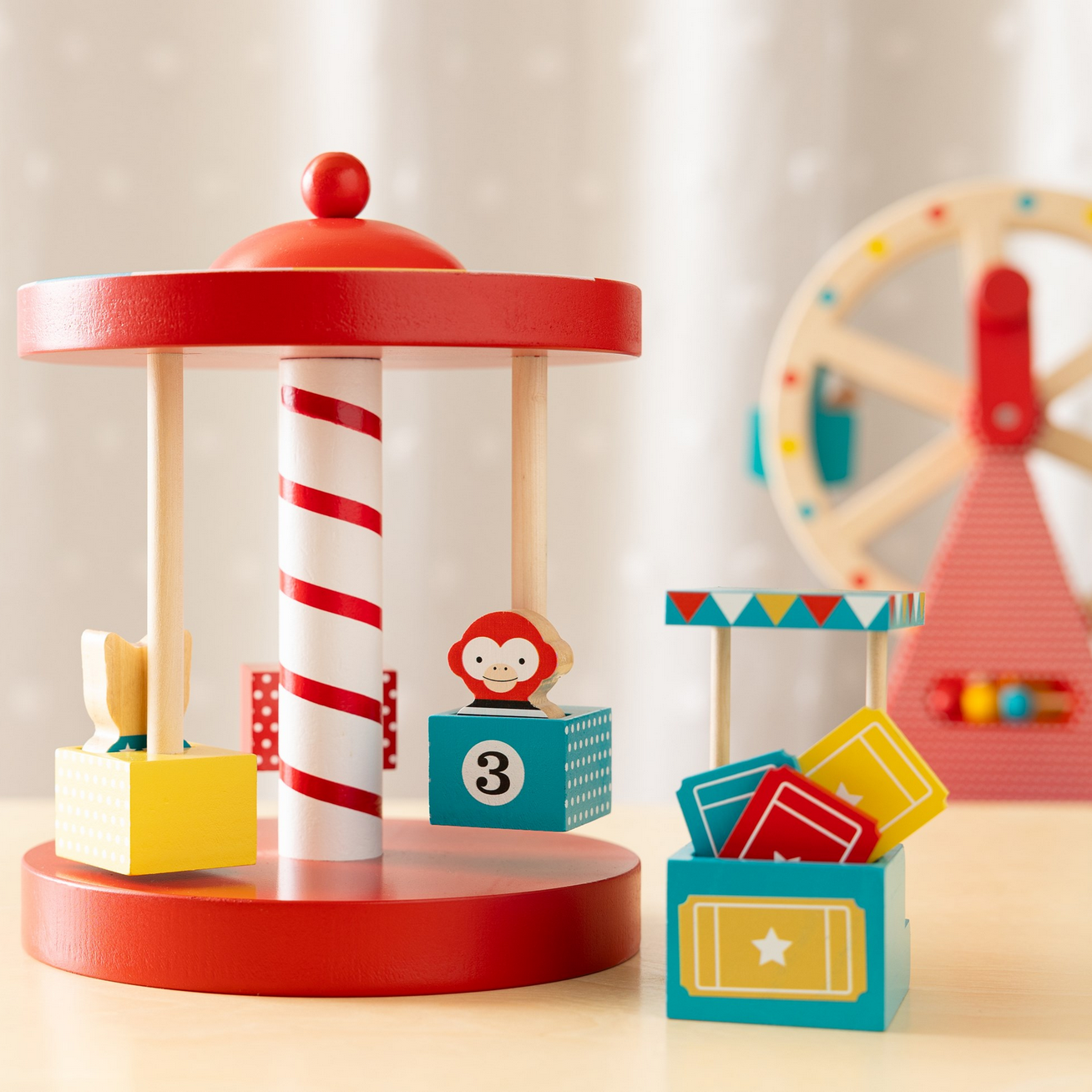 Colorful toy carousel with spinning top and wooden blocks on a light background