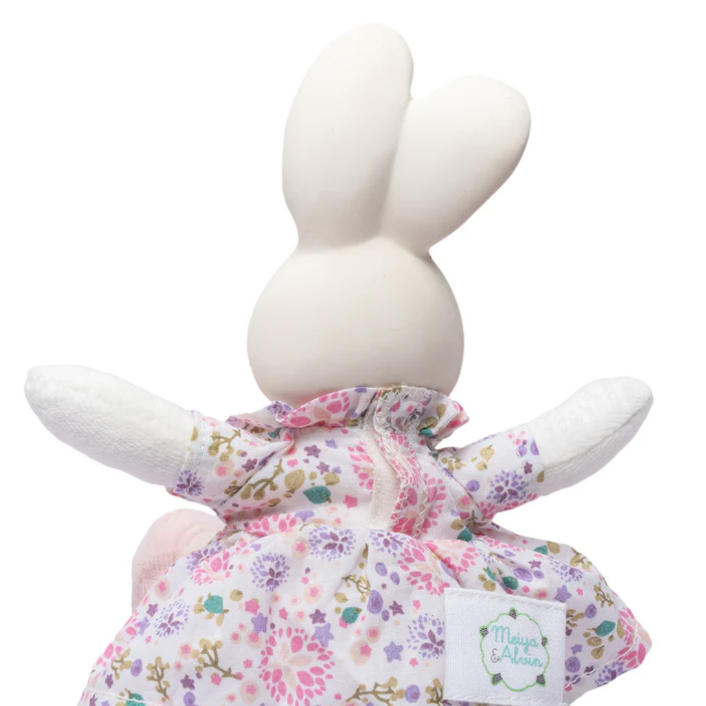 White bunny plush toy with a floral outfit on a white background