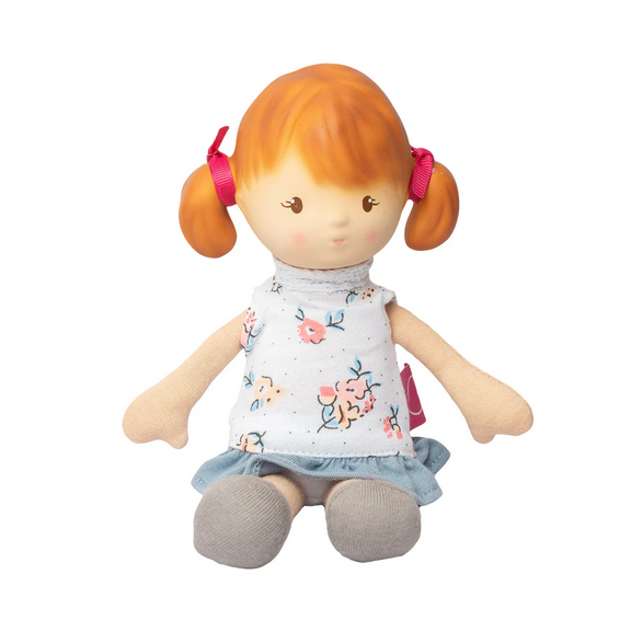 Toy doll with red hair and a white shirt on a white background