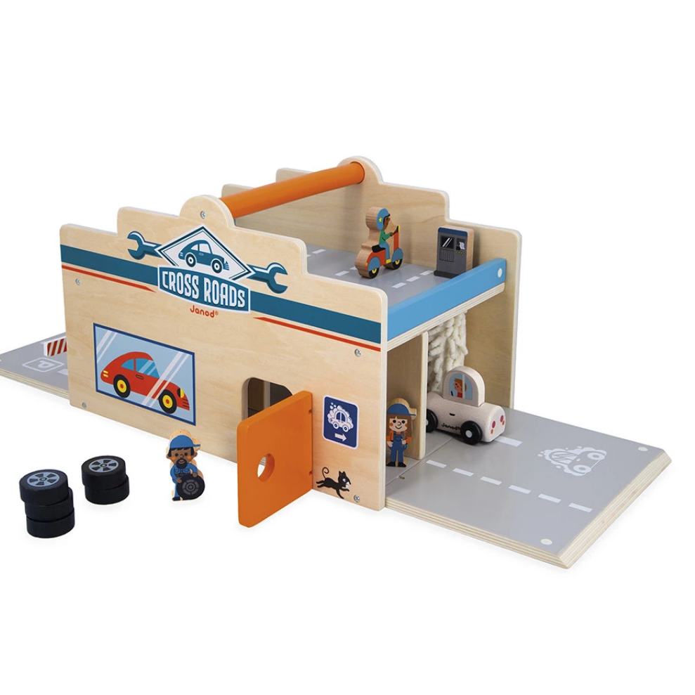 Toy garage set with various components on a white background
