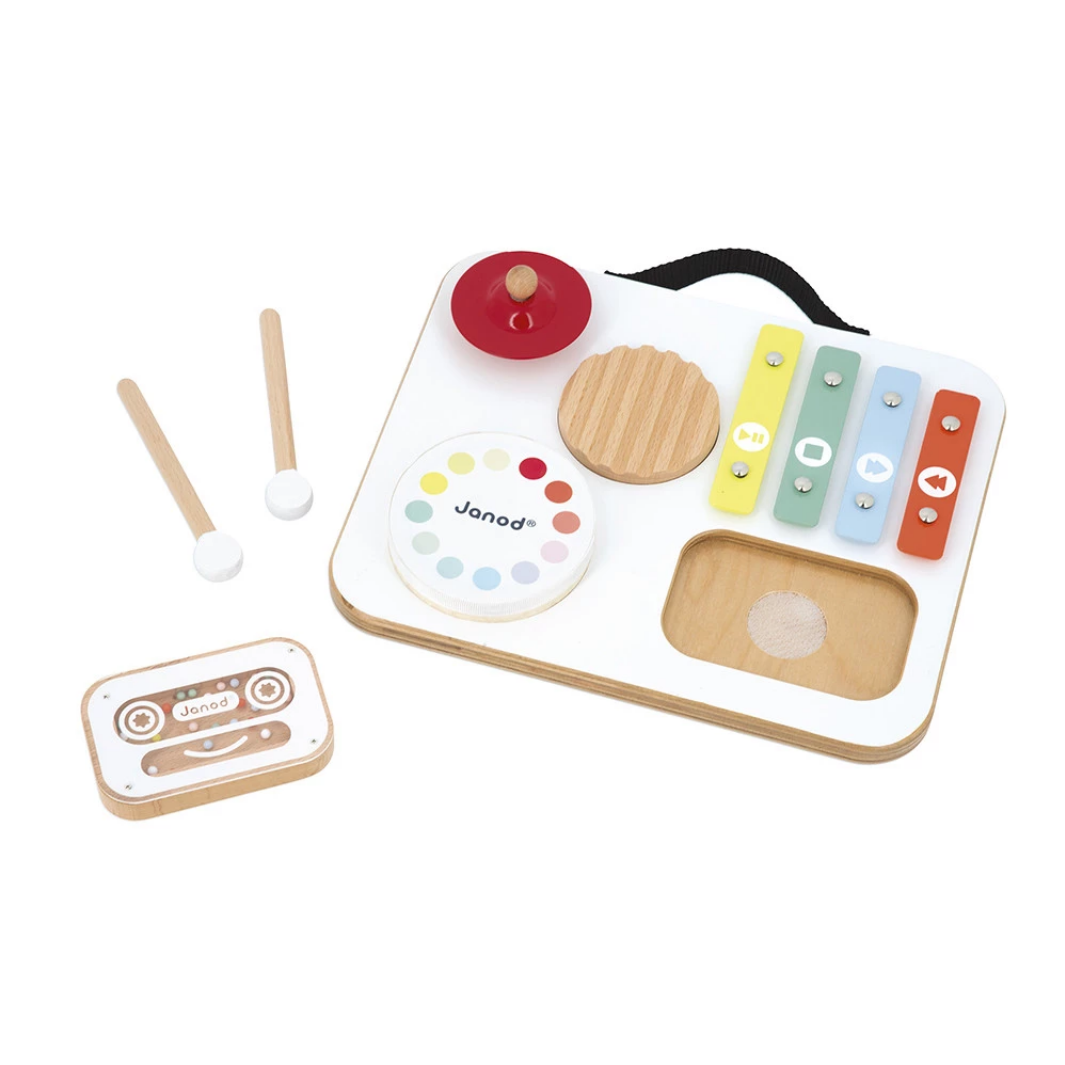 Set of wooden toys including a xylophone, drum, and other instruments on a white background.