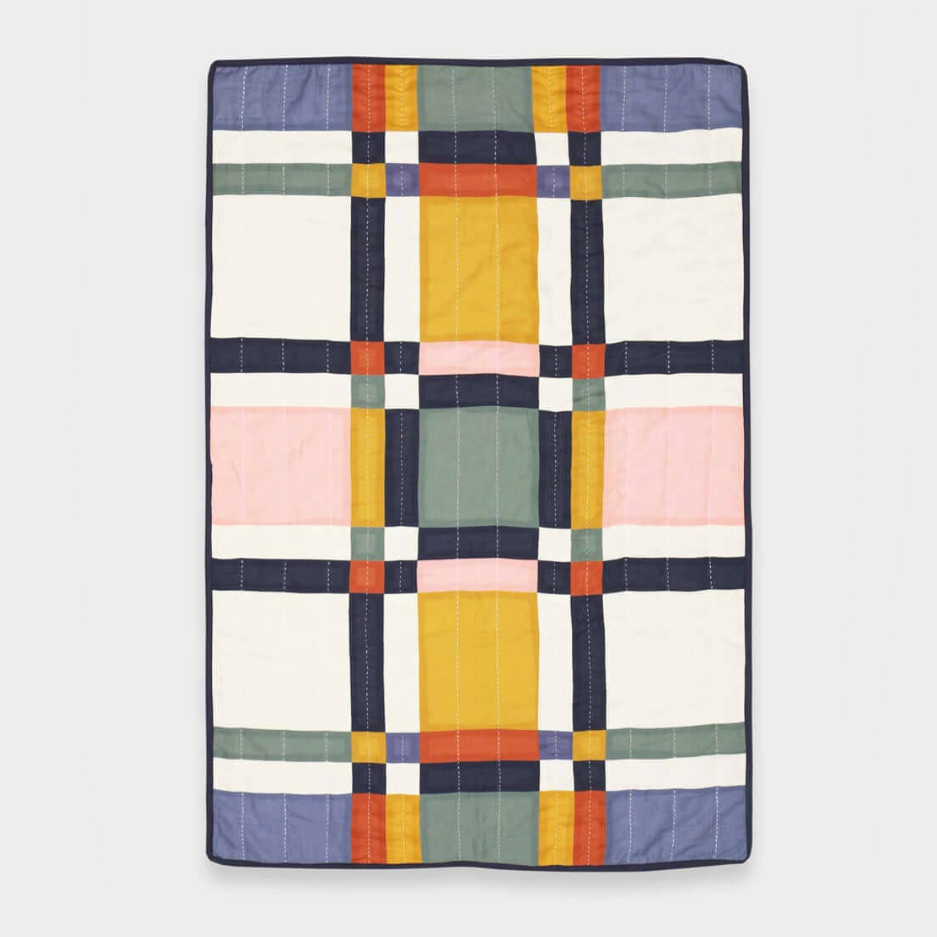Colorful quilt with geometric pattern on a white background