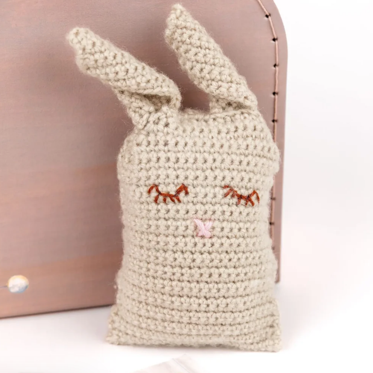 Crocheted bunny bag with face details on a light background