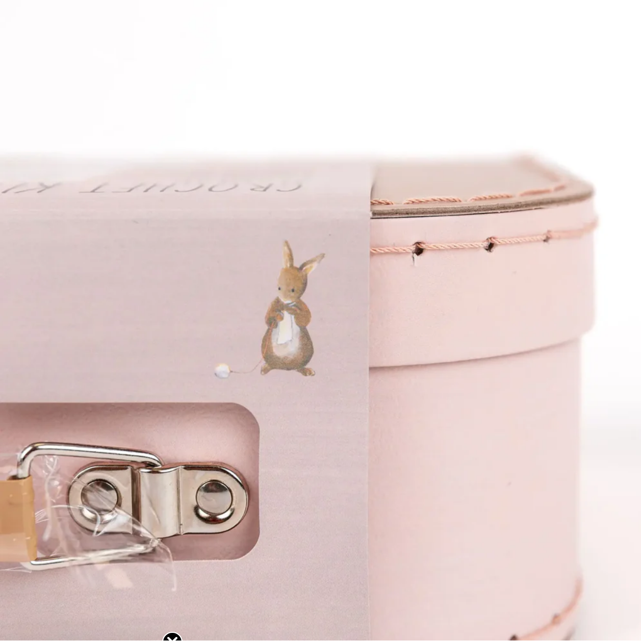 Pink jewelry box with a small rabbit illustration on a white background
