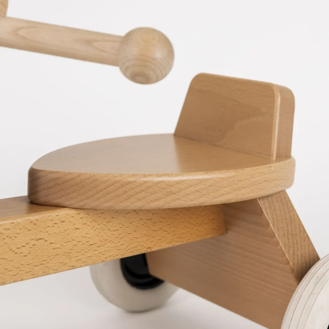 Wooden balance bike with a white background