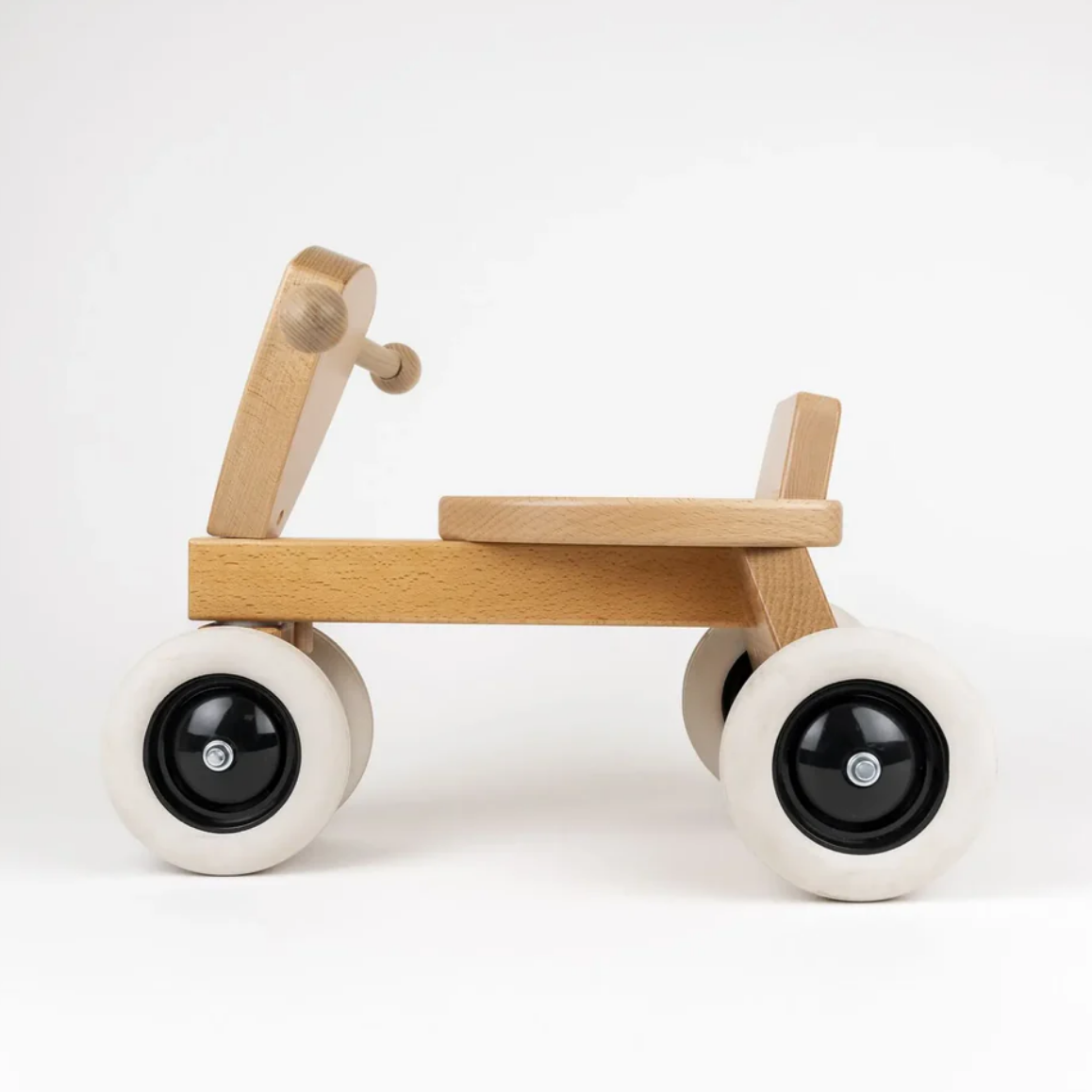 Wooden toy bike with white wheels on a white background