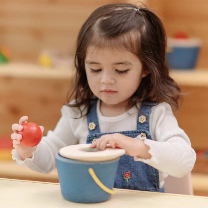 Child playing with toys in a classroom setting