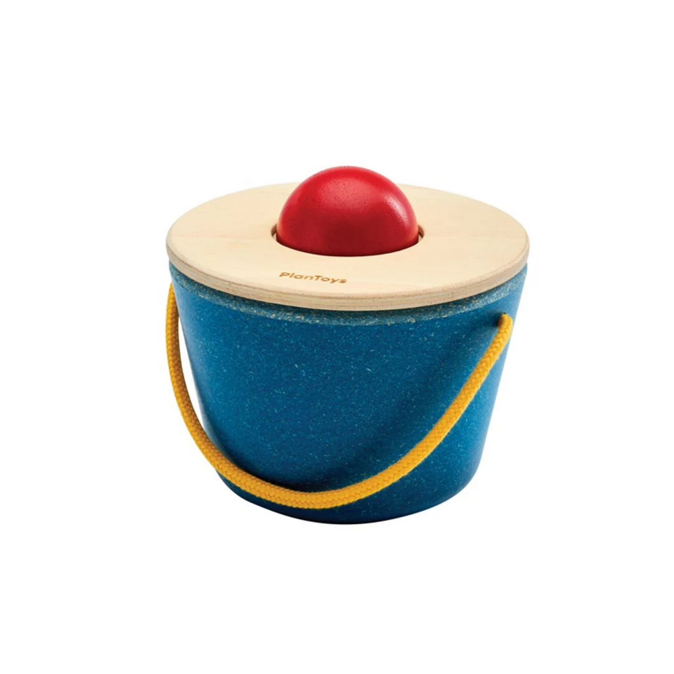 Wooden toy with a red ball on top and blue base, featuring the PlanToys logo.
