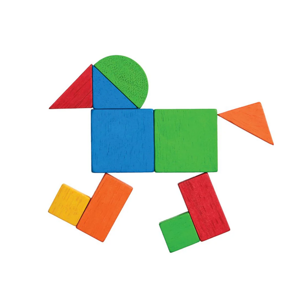 Colorful geometric block set arranged to resemble a bird on a white background