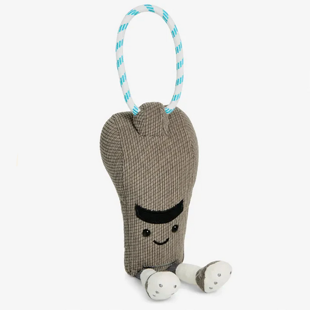 Plush toy resembling a shoe with a face on a white background