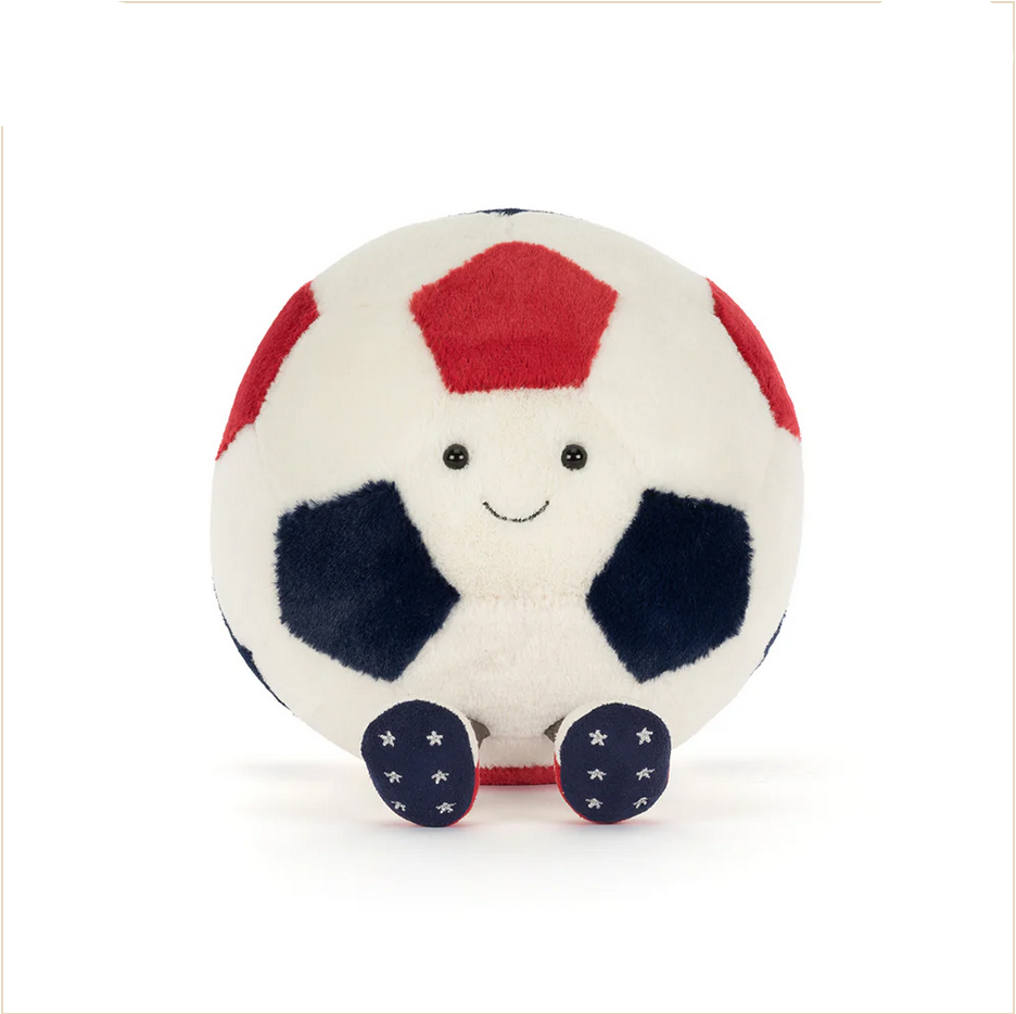 Plush toy soccer ball with a smiling face on a white background