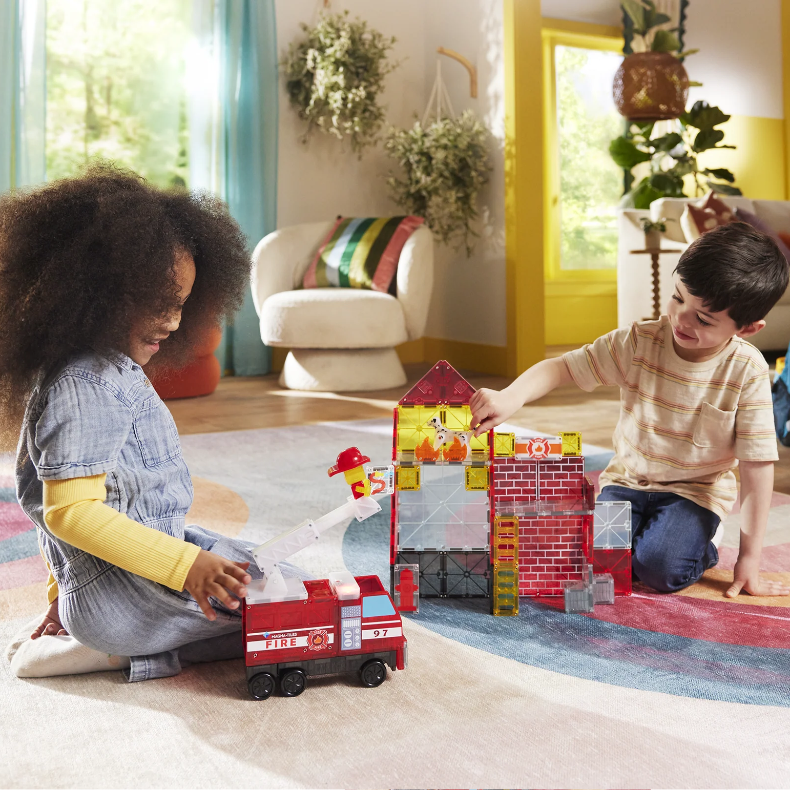 Two children playing with toy blocks on a colorful rug in a living room.