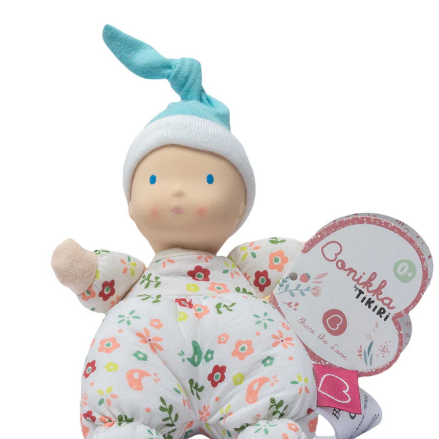 Baby doll with floral outfit and butterfly wings on a white background