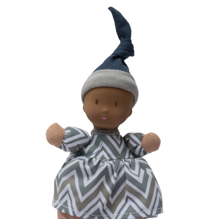 Waldorf doll with a striped dress and blue hat on a white background