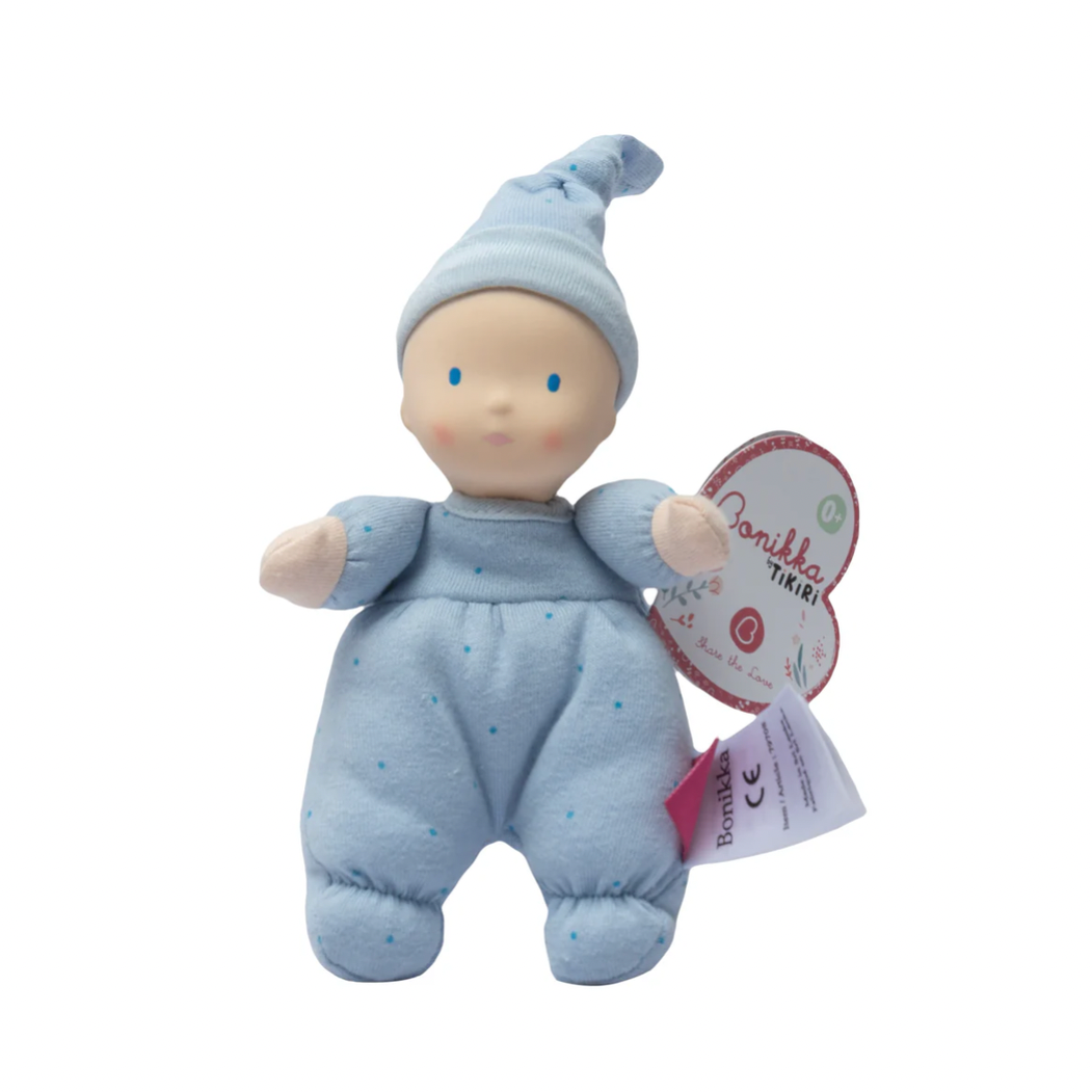 Baby doll in a blue outfit with a heart-shaped tag on a white background