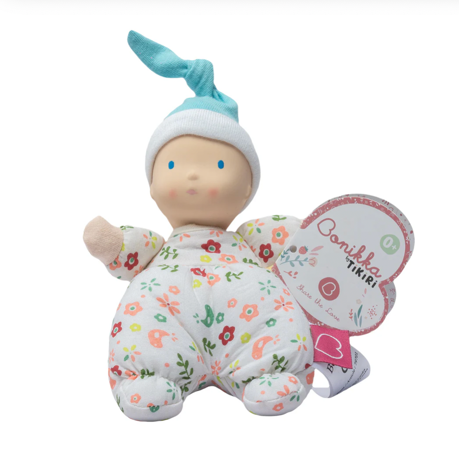 Baby doll with floral outfit  on a white background