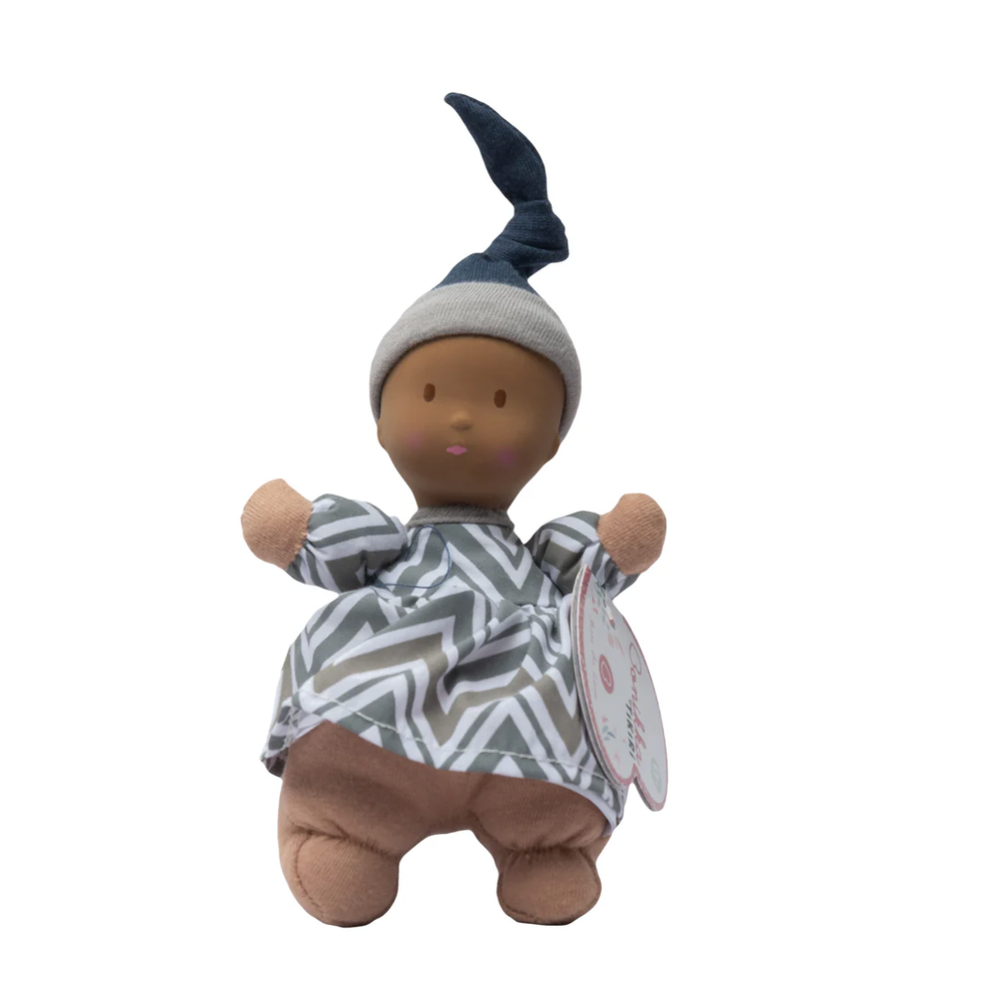 Baby doll with dark skin and striped outfit on a white background