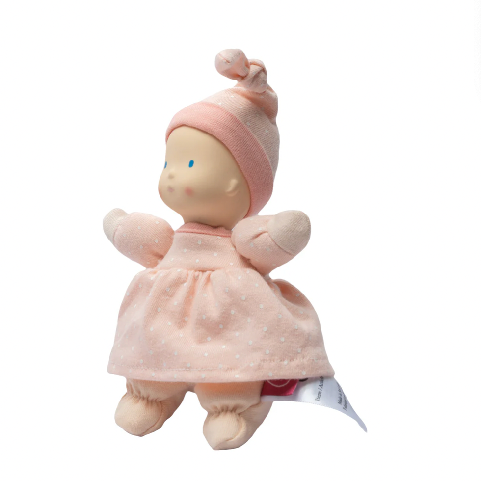 Baby doll with pink outfit and head on a computer screen with product listings.