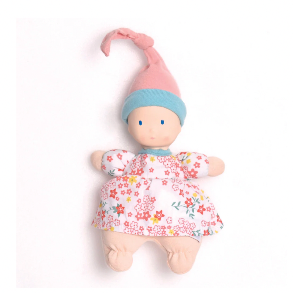 Baby doll with floral dress and pink hat on a white background