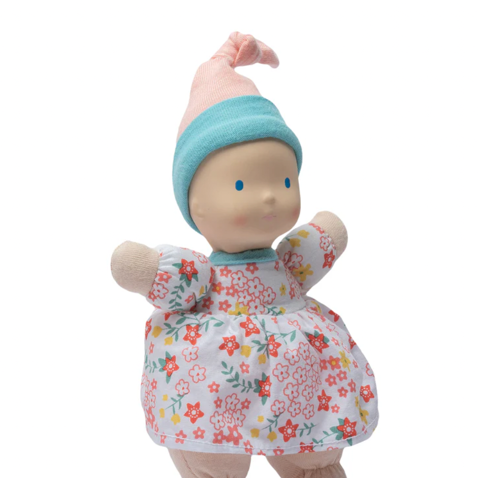 Toy figure with floral outfit and blue hat 