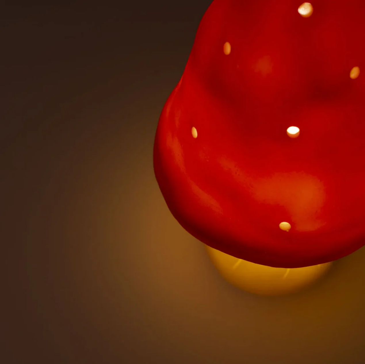 Red mushroom-shaped light fixture on a dark background