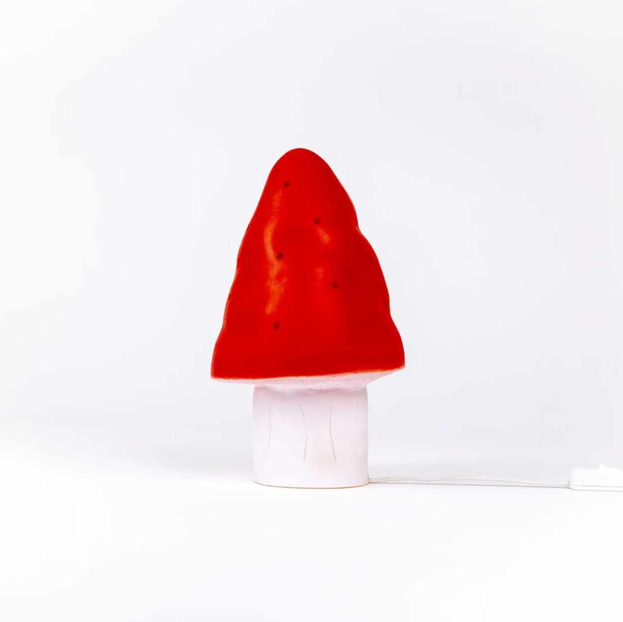 Red mushroom-shaped lamp on a white background