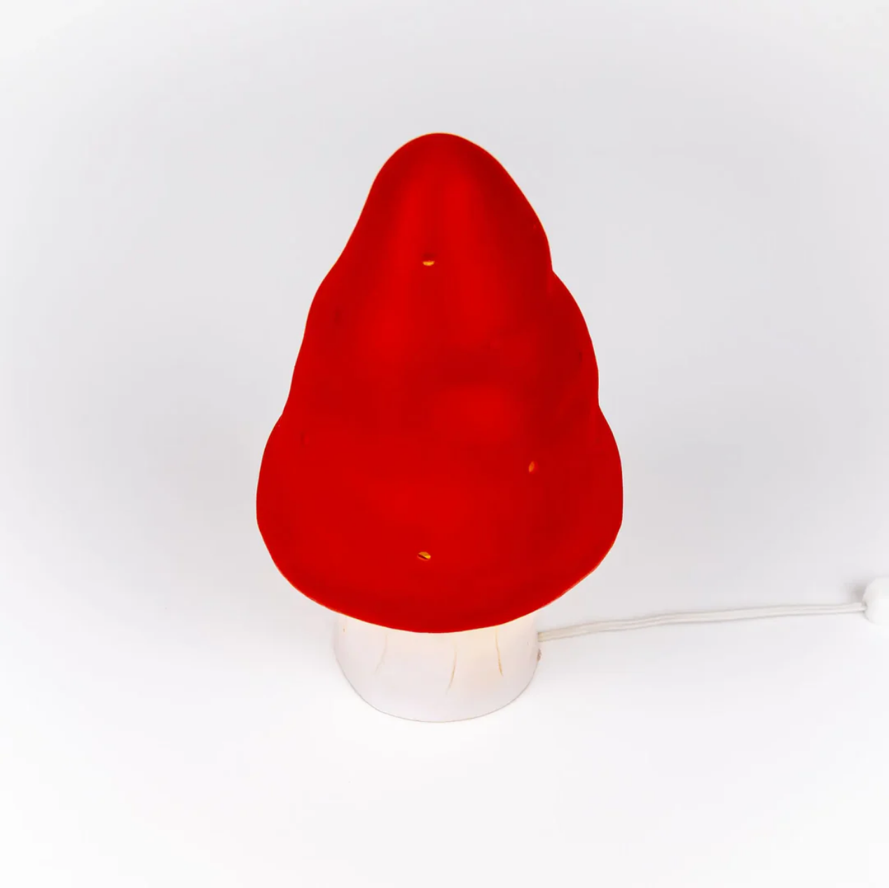 Red mushroom-shaped lamp on a white background