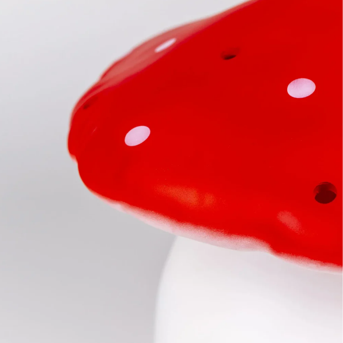 Close-up of a red object with white spots on a gray background