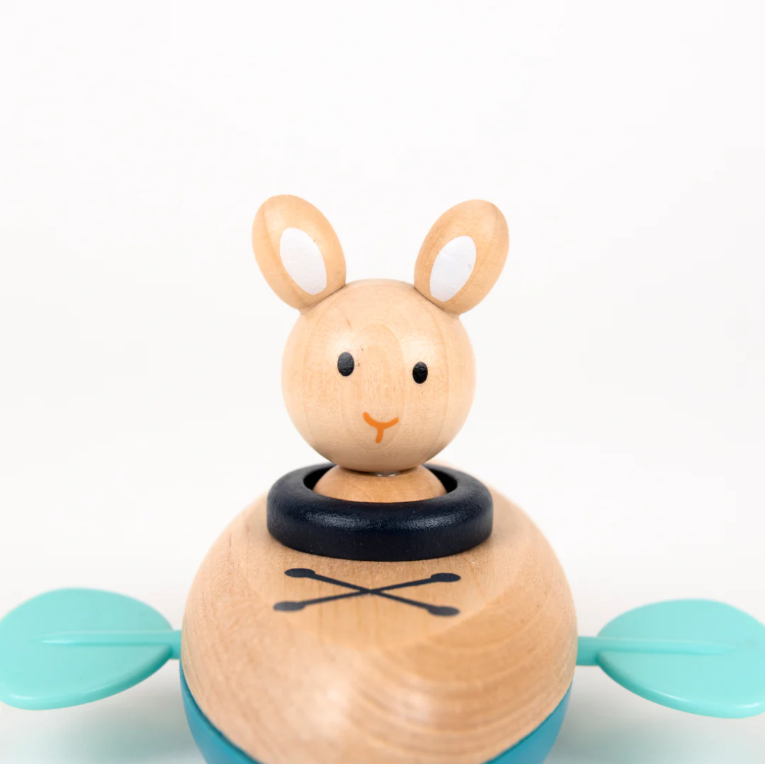 Wooden toy rabbit with a black ring on a white background