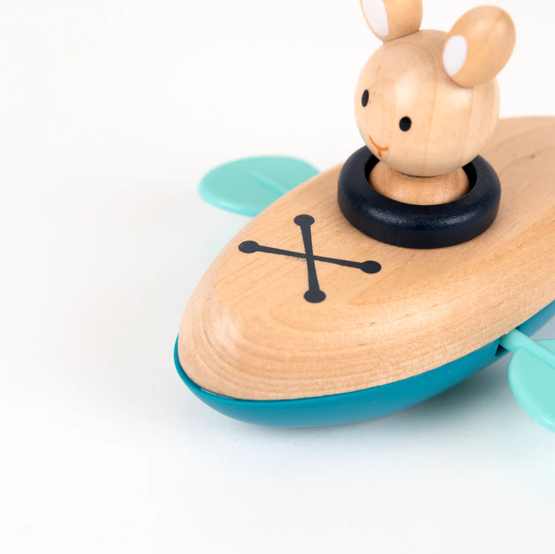 Wooden toy boat with a rabbit figure on a white background