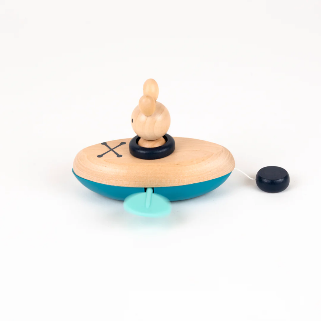Wooden toy with a small figure on top of a blue base on a white background