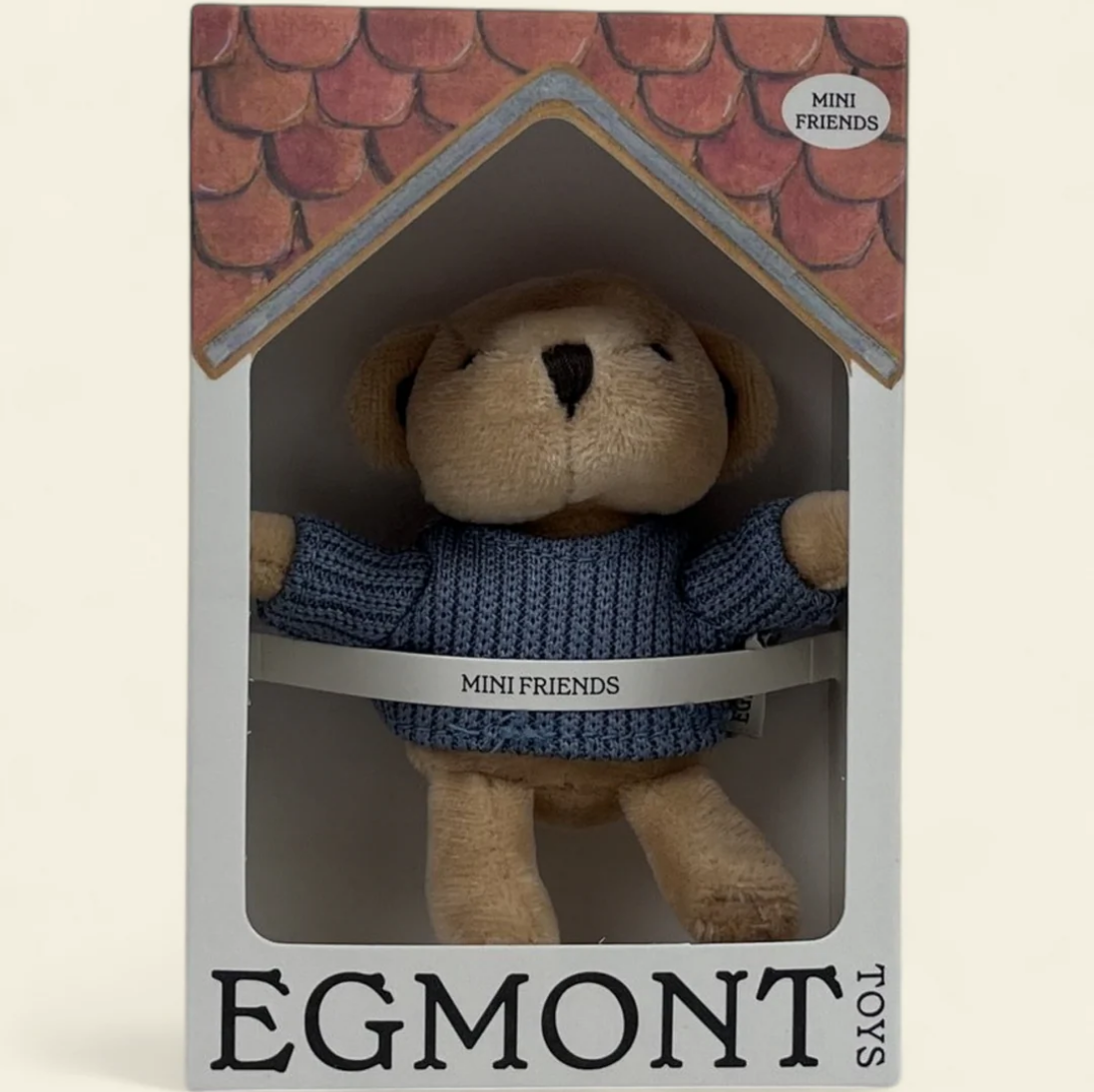 Stuffed toy dog in a blue sweater inside a packaging box with 'Egmont Toys' branding.