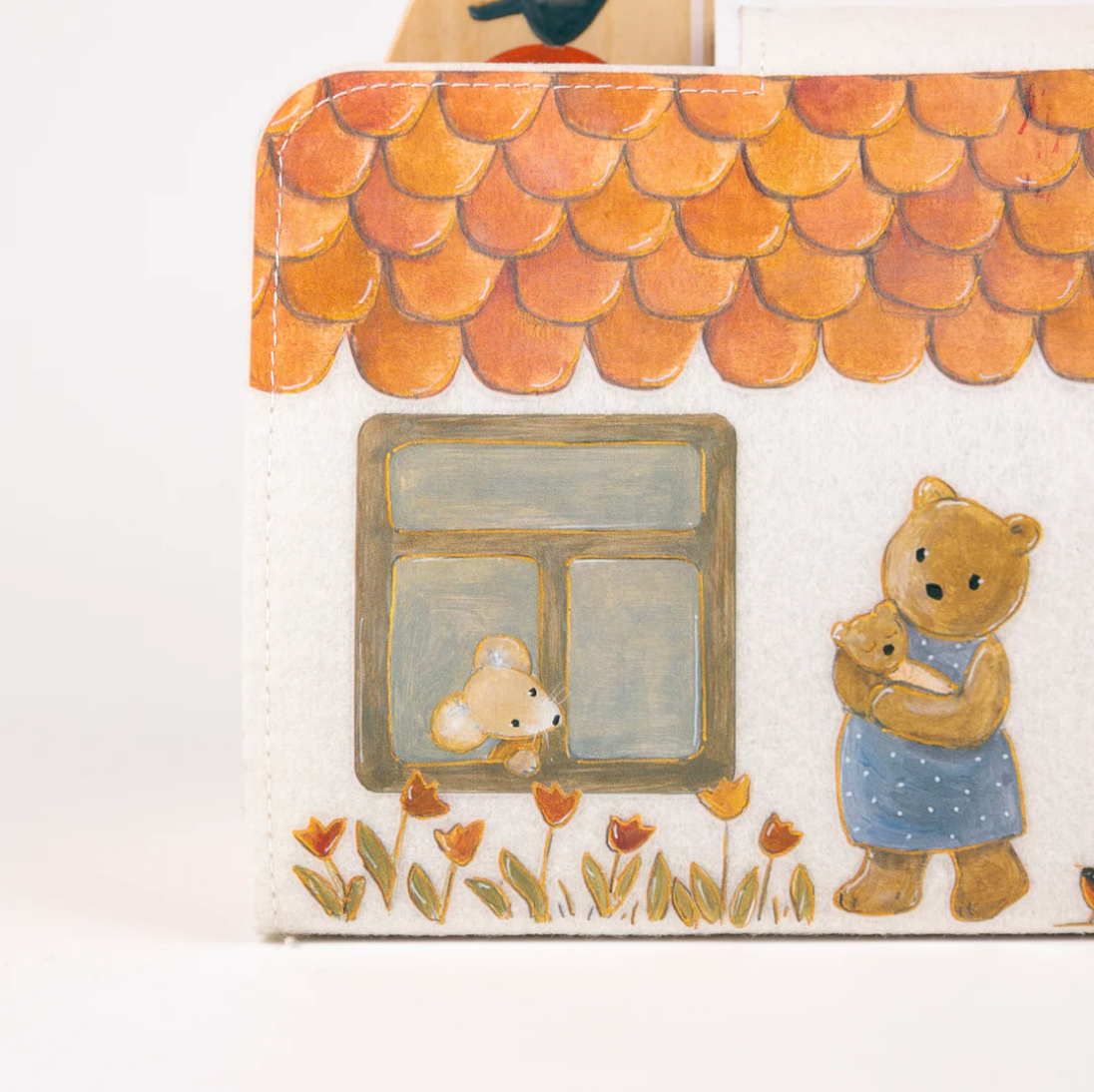 Children's dollhouse with teddy bear illustrations and a roof on the cover