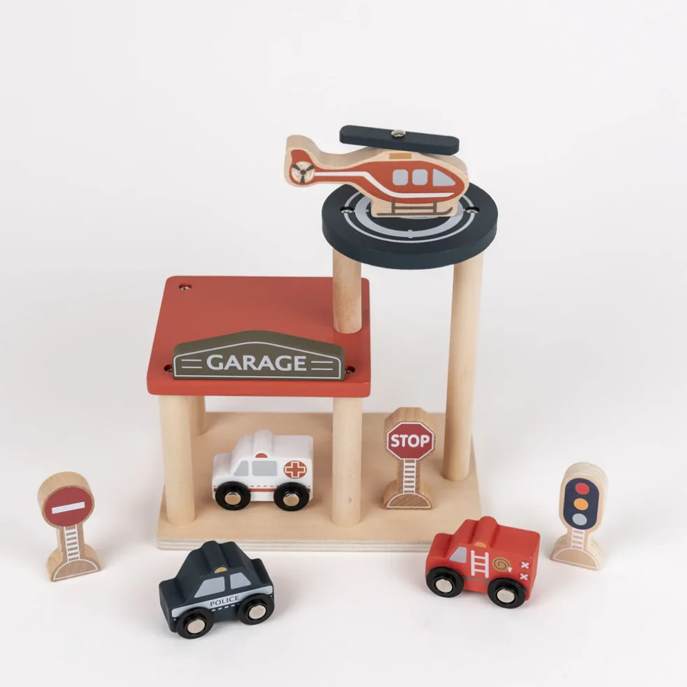 Wooden toy garage set with vehicles on a white background