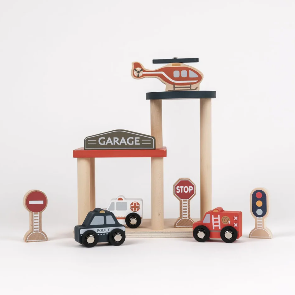 Wooden toy garage with toy cars and traffic lights on a white background