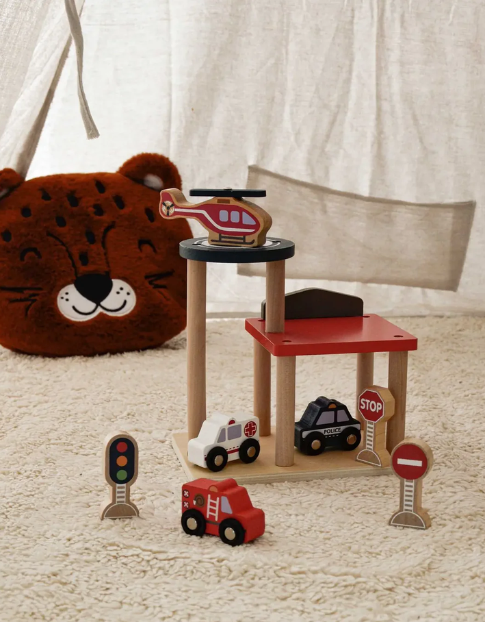 Children's toy set with wooden chairs, cars, and traffic lights on a carpeted floor.