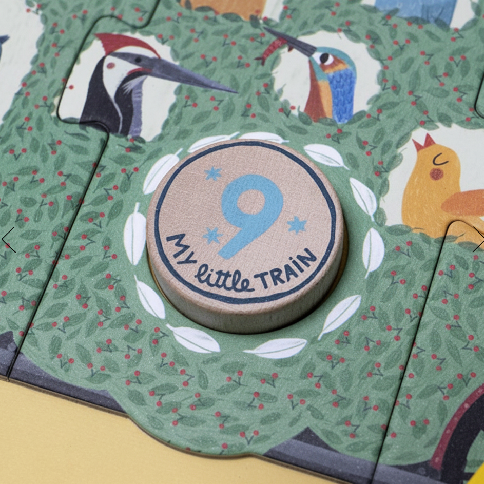 Children's puzzle with animal illustrations and a wooden disc labeled 'My Little Train 9'.