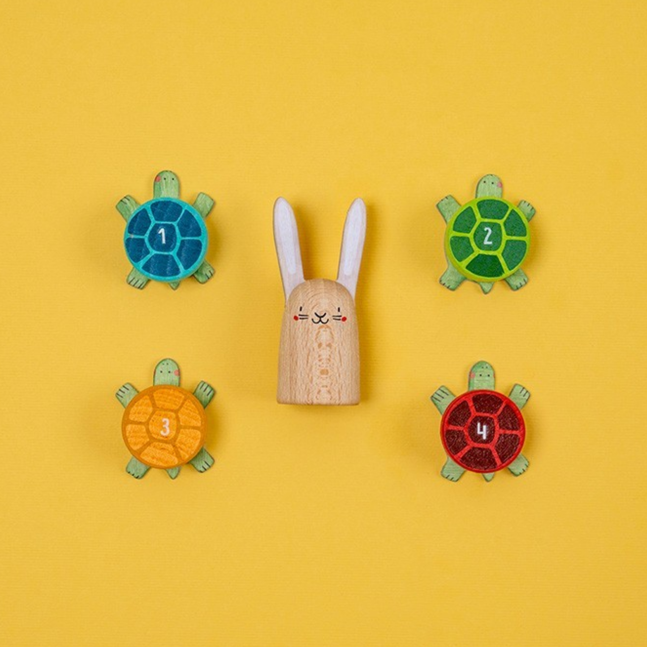 Wooden toy rabbit with number turtles on a yellow background