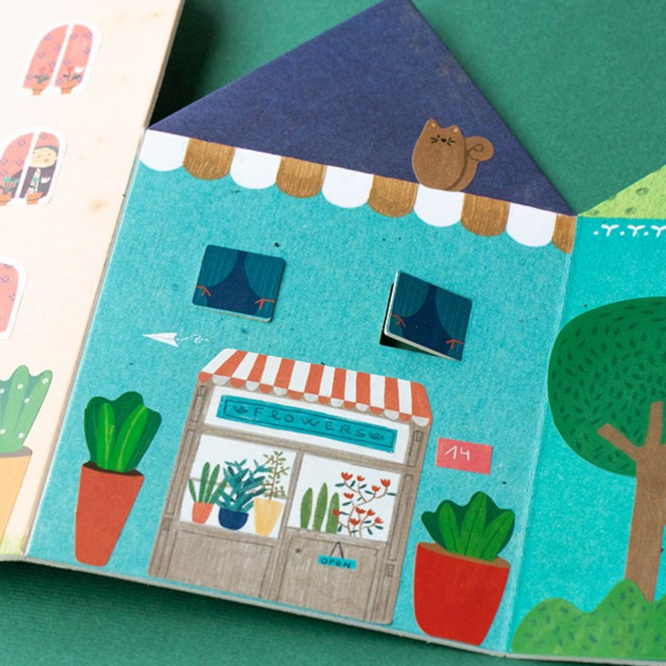 Illustrated children's book with a house and plant store on a green background