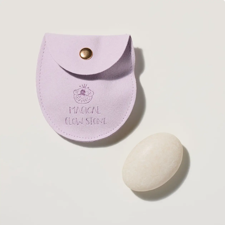 Purple pouch labeled 'Magical Glow Stone' with a white stone on a light gray background
