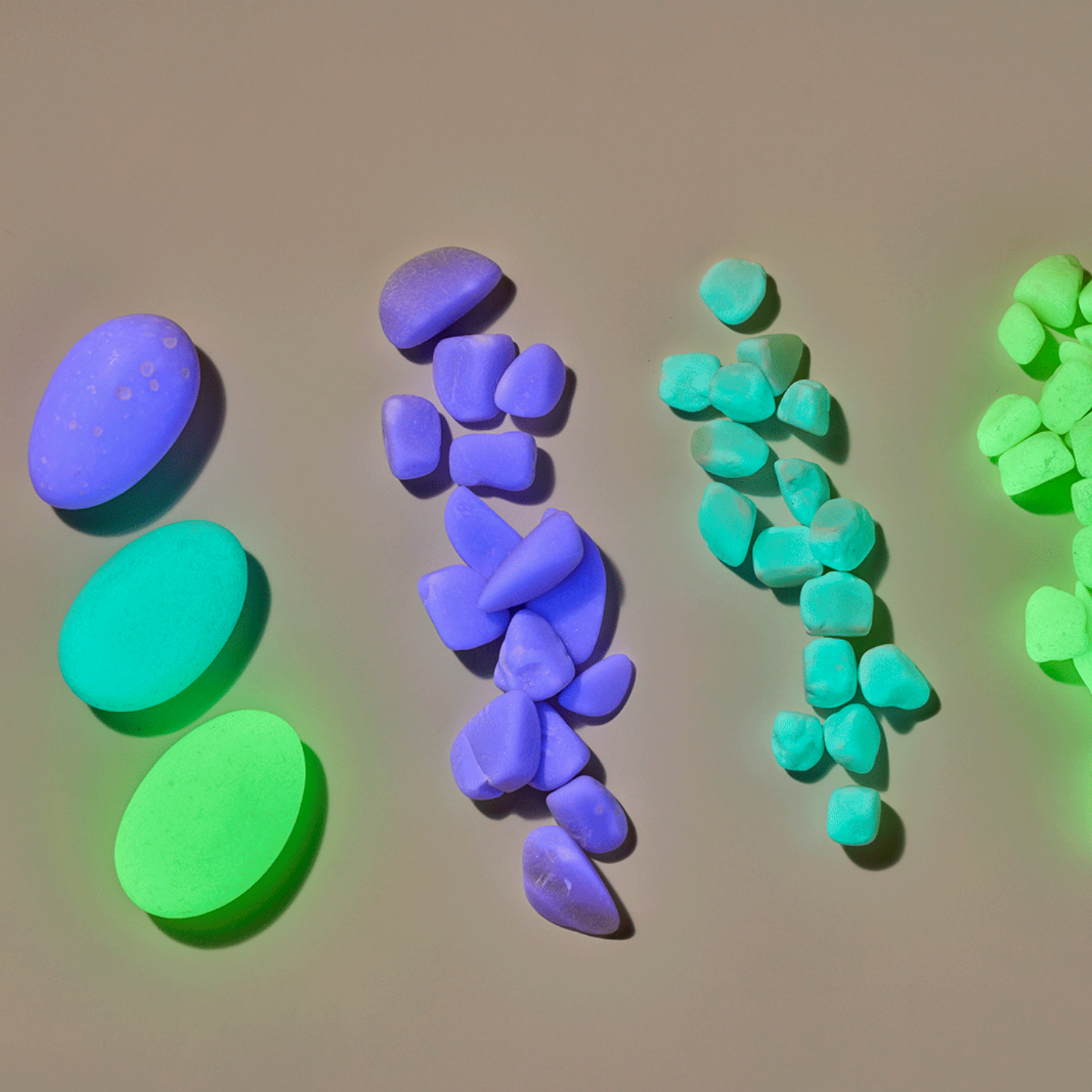 Colorful 3D geometric stones on a beige background