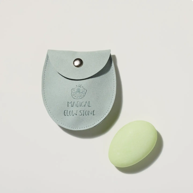 Light blue pouch labeled 'Magical Glow Stone' with a matching glowing stone on a light gray background