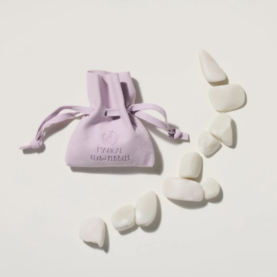 White chew toys with a purple drawstring bag on a light beige background