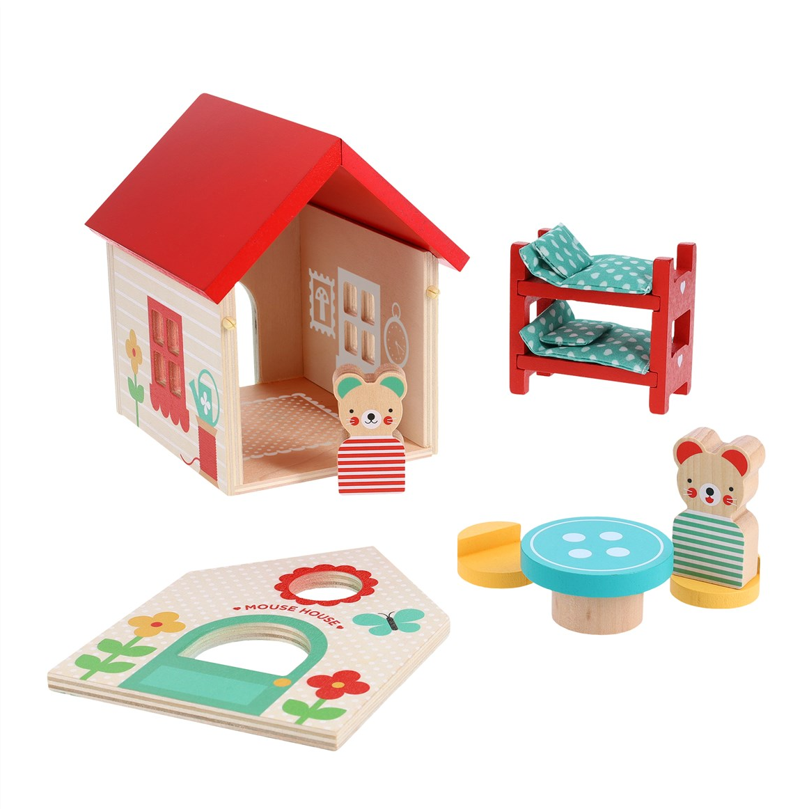 A children's wooden house play set on a white background, including a small house with a red roof, a bed with two colorful pillows, a round table with a blue top, and two bear-like wooden figures.
