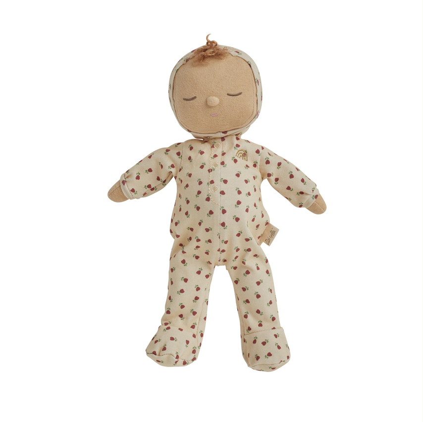 A handmade fabric doll with a beige cloth head and arms, wearing a cream-colored footed pajama suit with a small brown floral pattern, set against a plain white background.